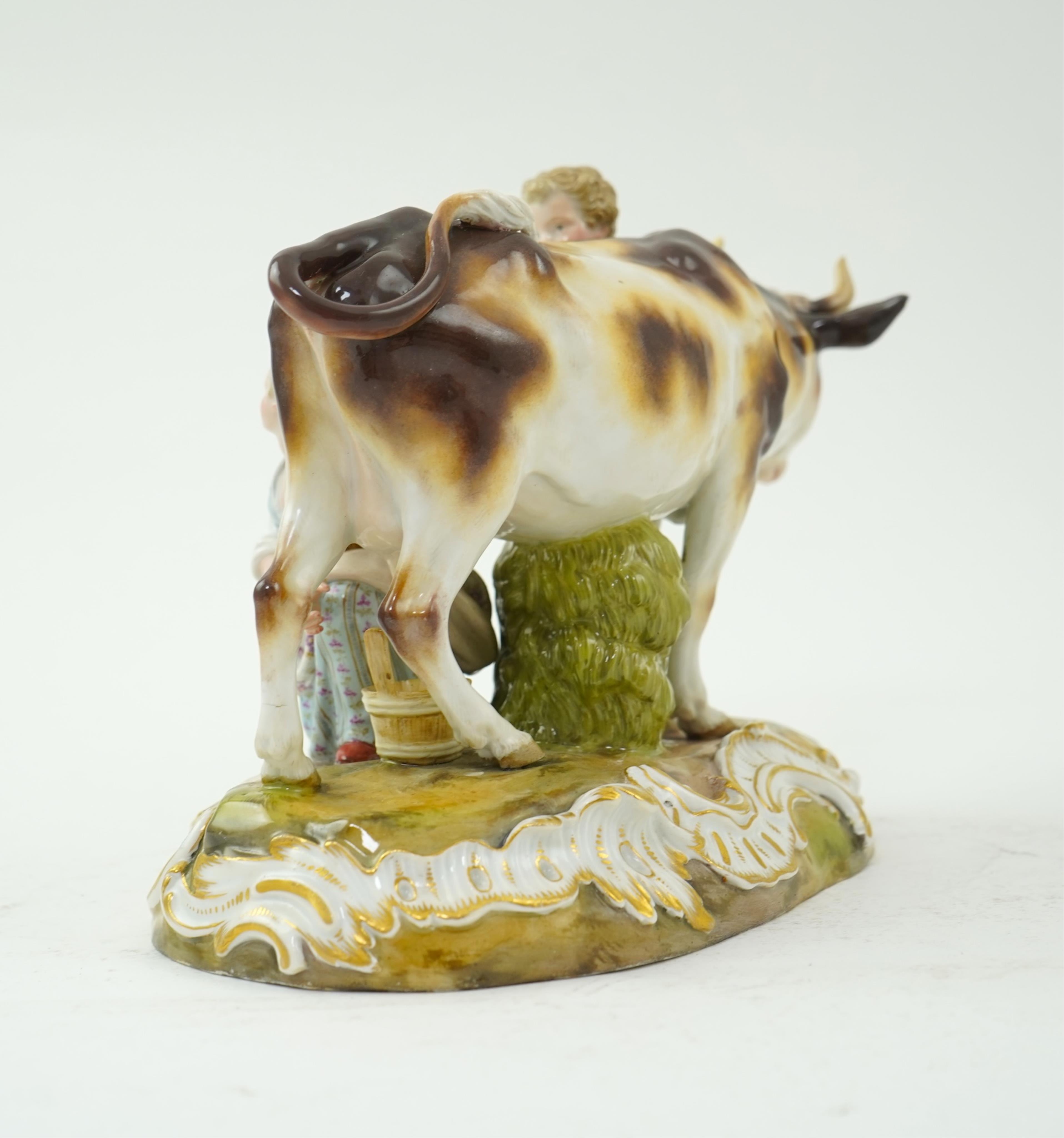 A Meissen group of a boy and girl milking a cow, 19th century